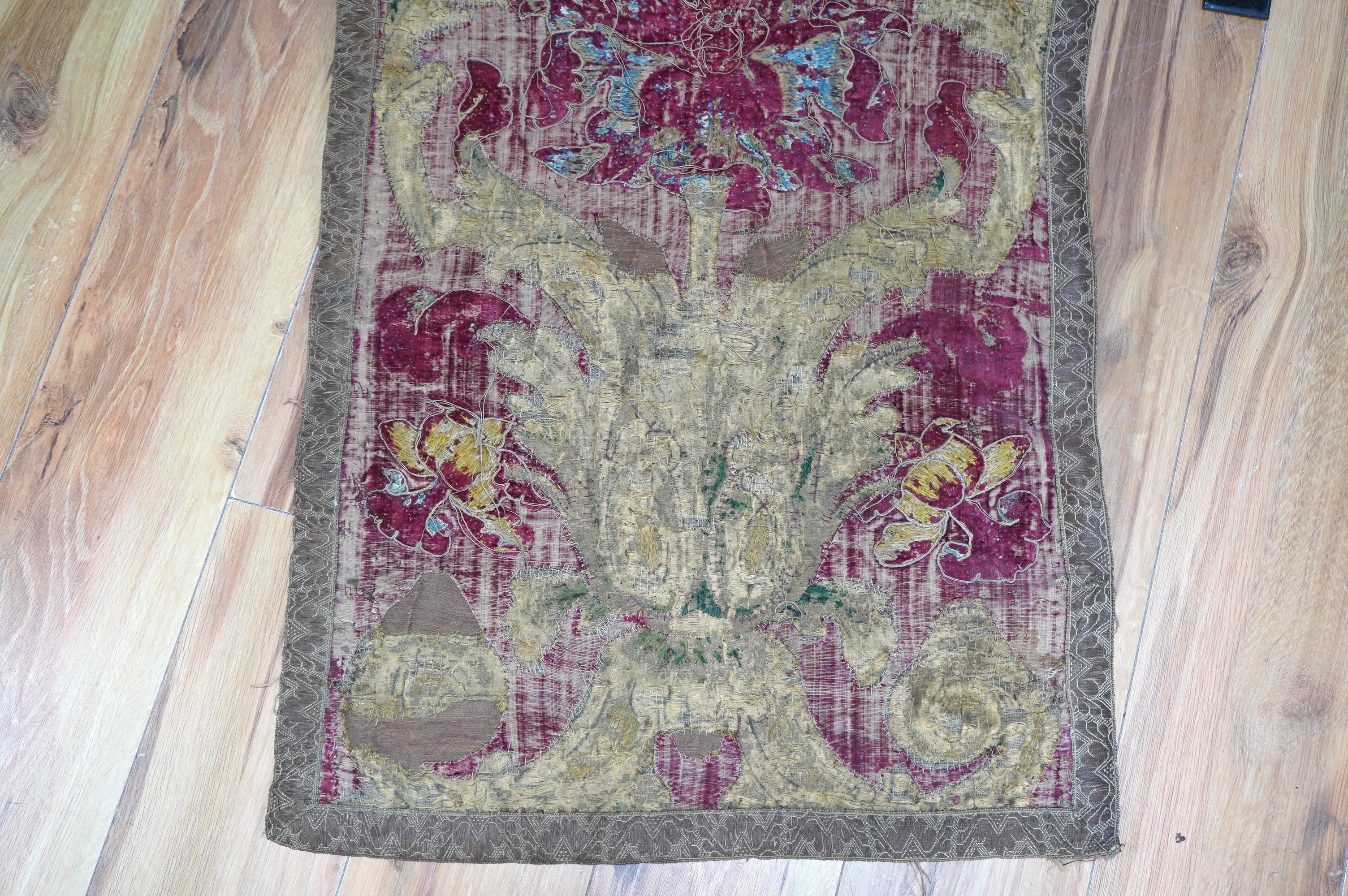 A fine Italian Renaissance style velvet, embroidered and appliqué wall hanging, originally part of a pilaster hanging, made with crimson silk velvet, gold appliqué and colourful polychrome silk embroideries of parrots an